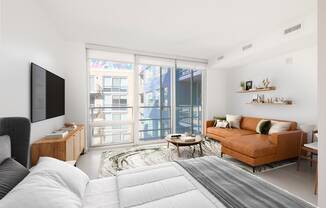 a bedroom with a bed and a couch in a room