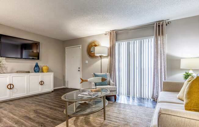 a living room with a couch and a table and a tv