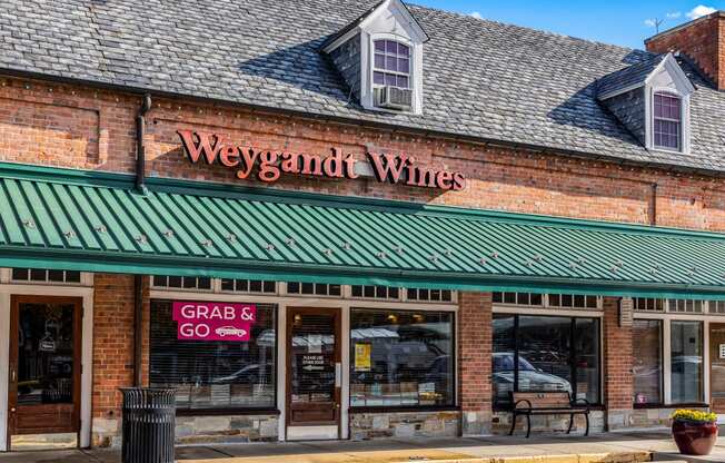 a brick building with a green roof and a sign that reads wines