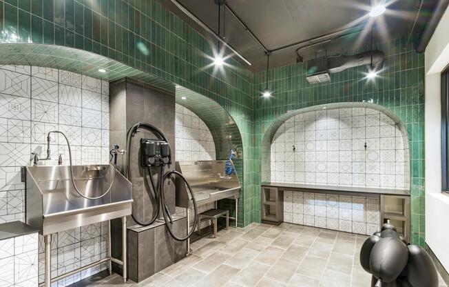 Pet wash station with tiled arches, stainless steel fixtures, and dedicated grooming space designed for easy cleanup and everyday care for your beloved companions.