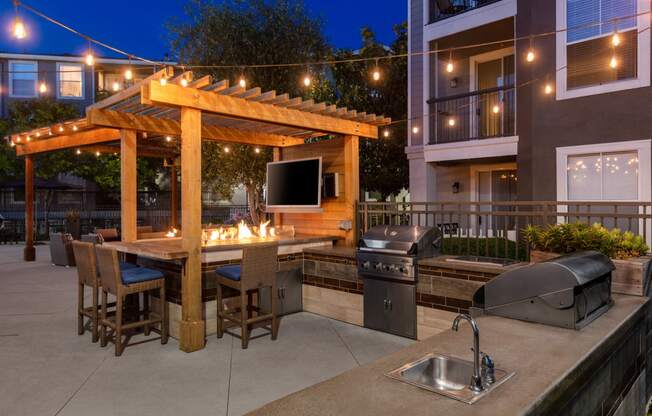 Outdoor grill and seating area with TV