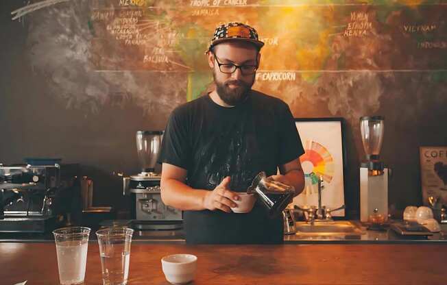 Man Brewing Coffee in a Cafe