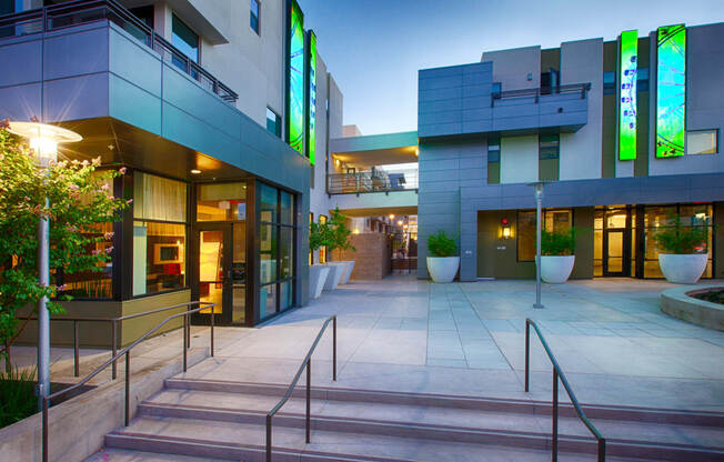 a picture of the front entrance of a building at night