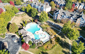 An aerial view of a residential area with a swimming pool and apartment buildings.