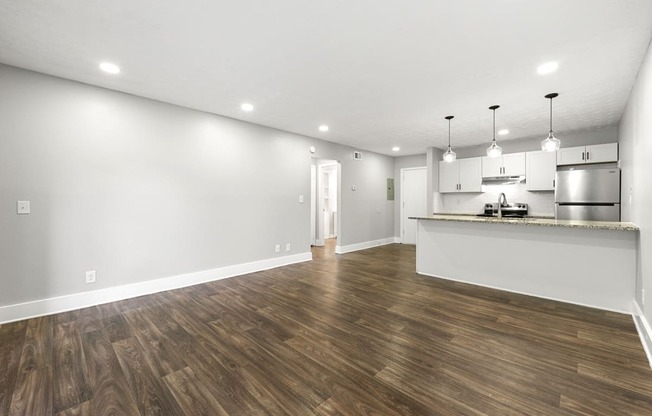 Living room with updated flooring and private patio at Balfour Chastain, Sandy Springs, GA