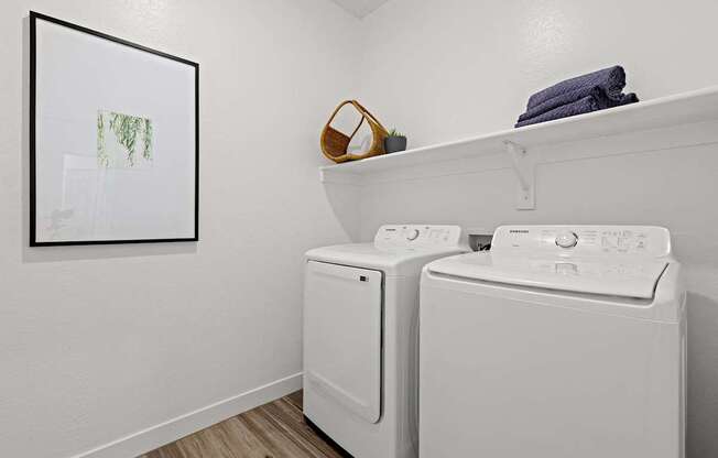 A small laundry room with a washer and dryer.