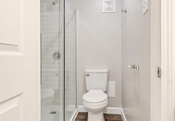 a bathroom with a toilet and a glass shower