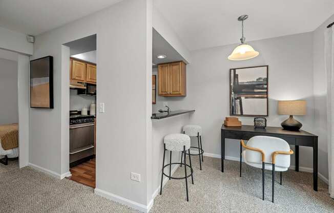 A kitchen with a table and chairs in the middle of the room.