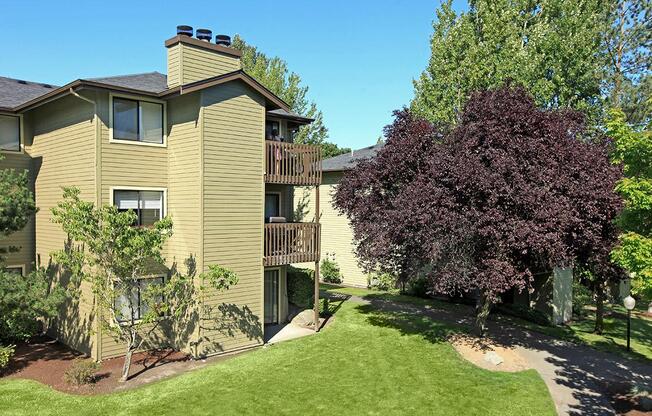 Building Exterior with Green Walkways, Trees and Grass