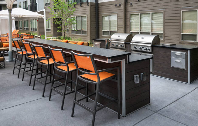 Image of two gas grills and outdoor bar
