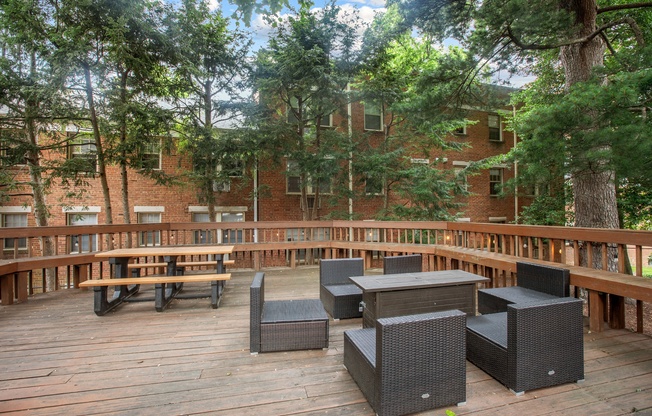 a patio with tables and chairs on a deck