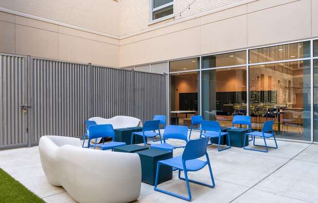 A white bean bag chair sits in front of a glass wall.