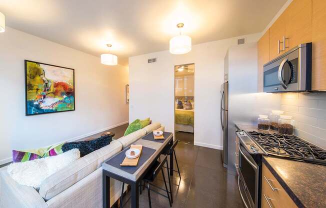 A kitchen with a stove top oven and a microwave above it.