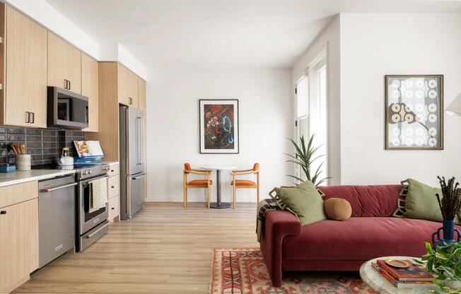 Open-concept living with light wood cabinetry, stainless steel appliances, and space to dine, unwind, and entertain with ease.