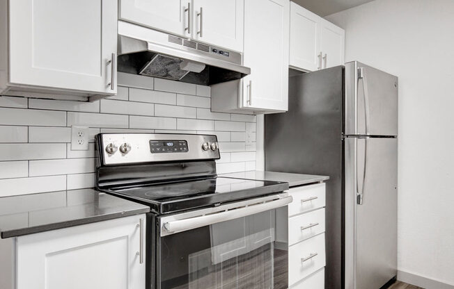 a kitchen with a stove and a refrigerator