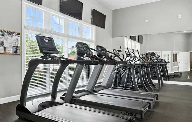 A row of treadmills in a gym.