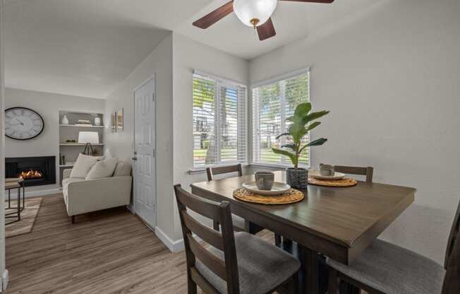 a dining room and living room with a table and chairs