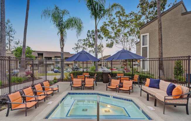 A pool surrounded by chairs and umbrellas.