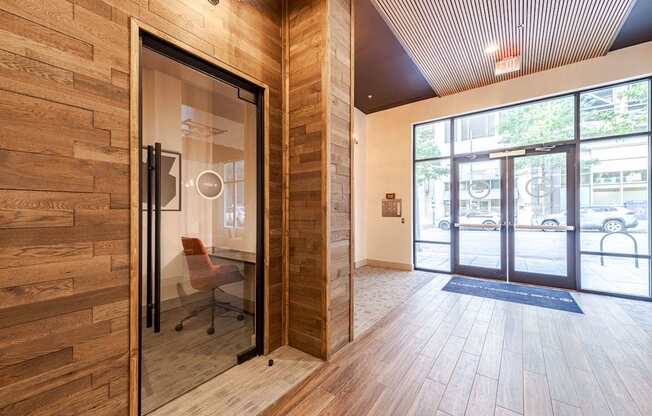 A room with a glass door and a wooden wall.