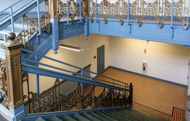 a view of the stairs in a building with blue railing and a door at Residences at South High, Pittsburgh, 15203 ? 