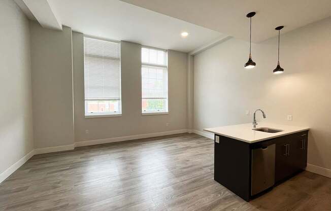 A kitchen area with a sink and a window.