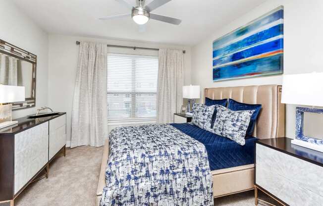 Westwood Green Apartments Master bedroom with wall to wall carpet, ceiling fan and large windows