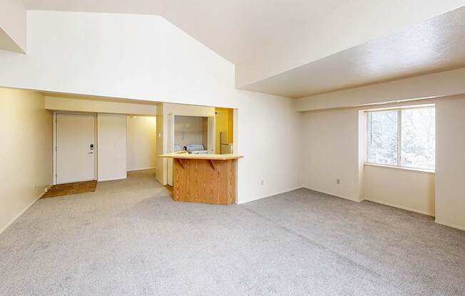 An enlarged living room with a cathedral ceiling at Foxwood and The Hermitage, Portage, MI