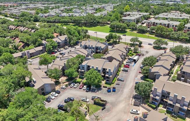 an aerial view of a neighborhood with houses and cars parked