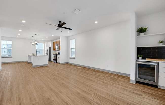 a large room with a wooden floor and a clock on the wall at Meridian at CityPlace, Woodbury, 55125