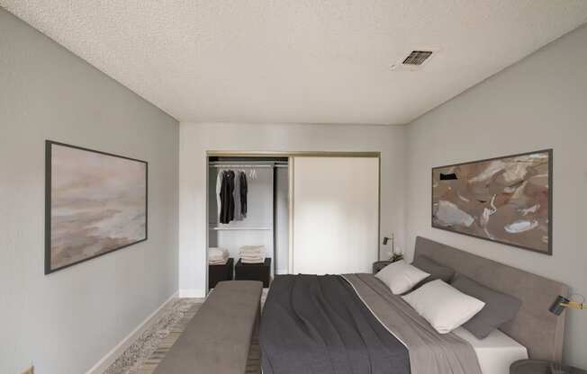 a bedroom with a bed and a sliding door to a closet