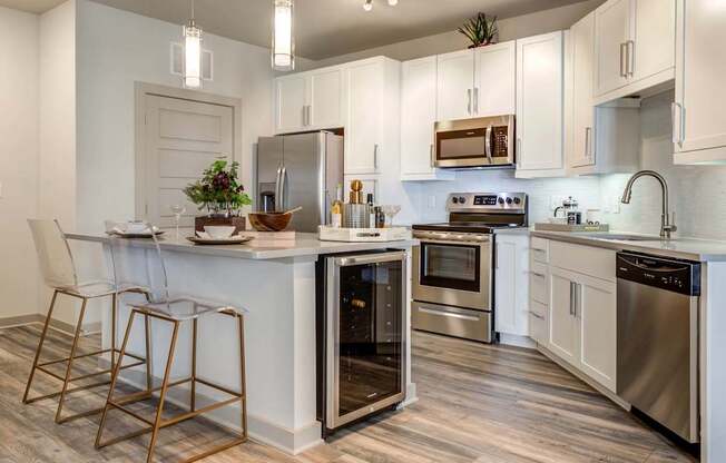 A modern kitchen with a white and wood color scheme.