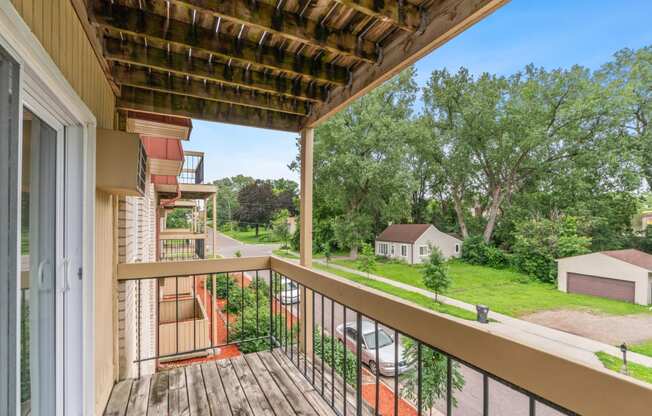 the view from the balcony of a house with a wooden railing and a wooden deck