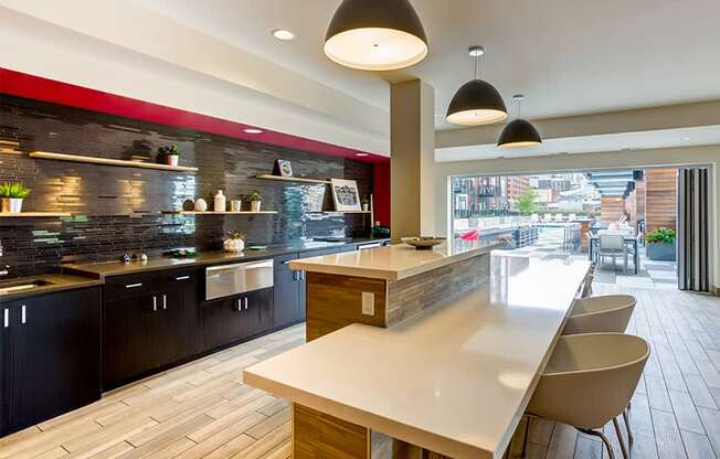 a kitchen with a long counter and a table and chairs