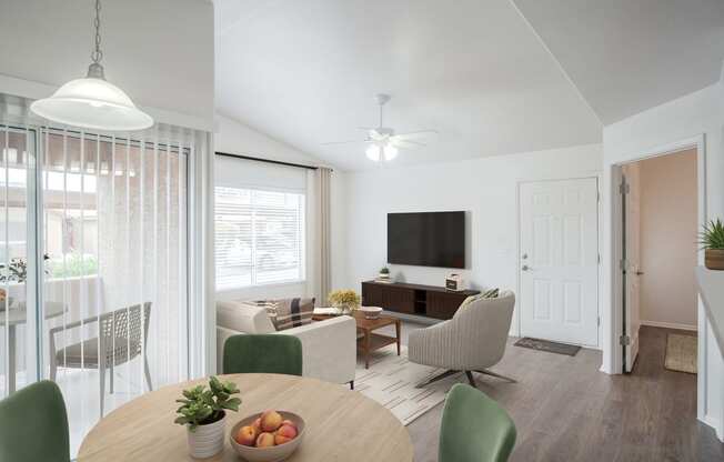 a living room and dining room with a table and chairs