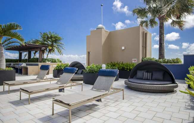 a patio with chairs and tables and a building in the background