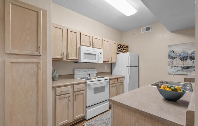 a kitchen with white appliances and wooden cabinets