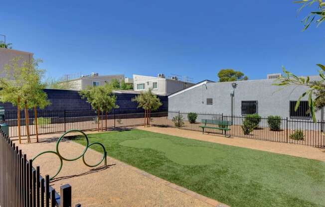 a fenced in yard with a tennis court and benches