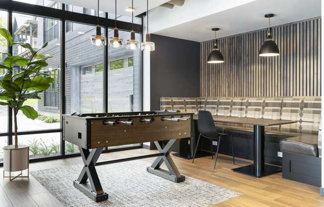 a pool table in a living room with a bar