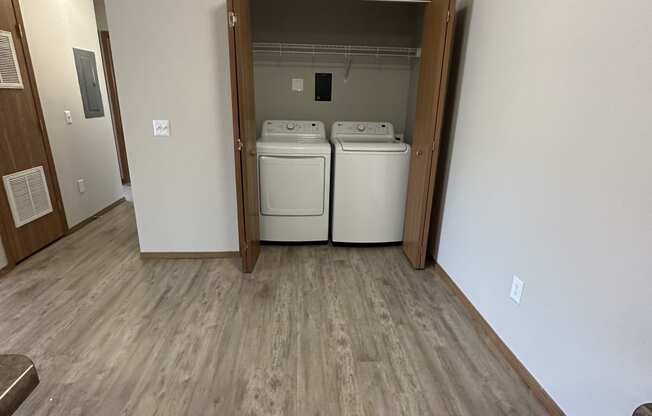 an empty room with a washer and dryer in it