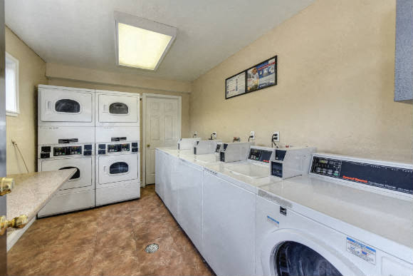 Community Laundry Room with Washers and Dryers, Hardwood Inspired Floors and Ceiling Light