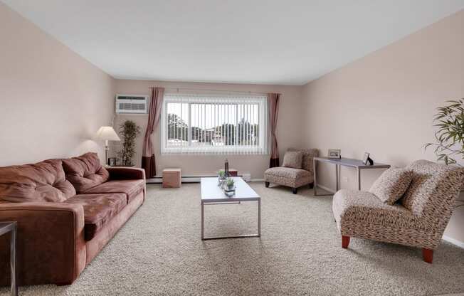 a living room with a leather couch and a coffee table at St Charles Square Apartments, Carol Stream, IL, 60188