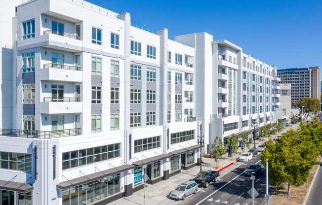 a large white building with a street in front of it