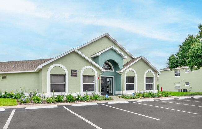 Clubhouse exterior with parking lot_Rolling Hills Apartments