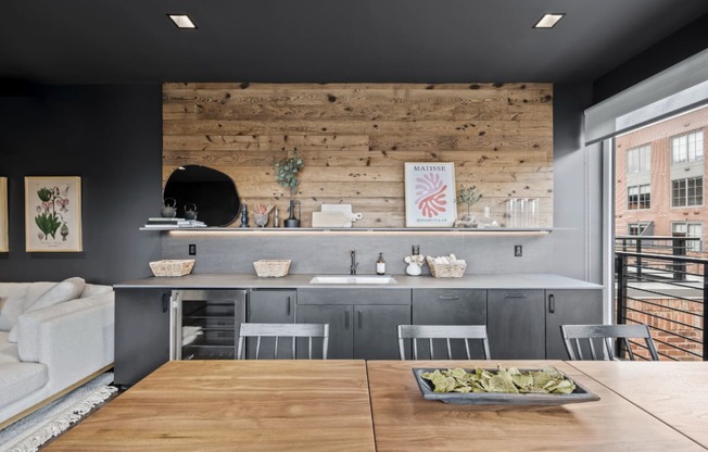 a kitchen with a wooden wall and a table with chairs