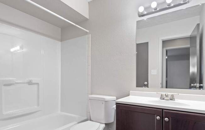 A white toilet sits next to a sink in a bathroom.