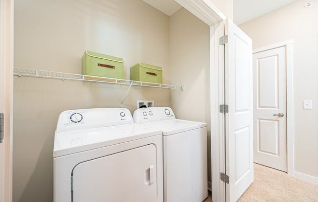 a washer and dryer in a laundry room with a closet
