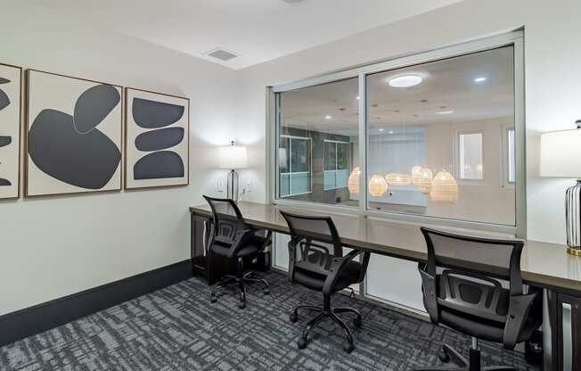 a conference room with a desk and chairs and a window