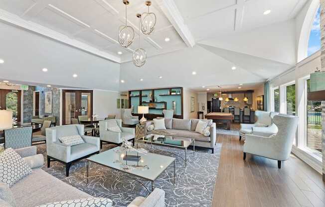 A spacious clubhouse with a variety of seating options and a patterned rug.