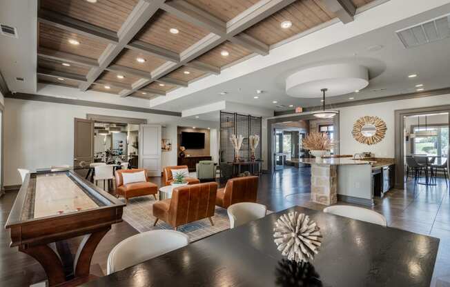 a large room with a table and chairs and a pool table