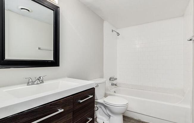 a bathroom with a toilet and a sink and a mirror